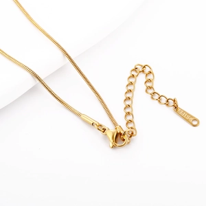 Macro view of 18k gold plated stainless steel lobster clasp and adjustable extension chain