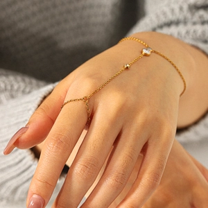 Elegant gold-tone stainless steel hand chain bracelet with white cubic zirconia accents