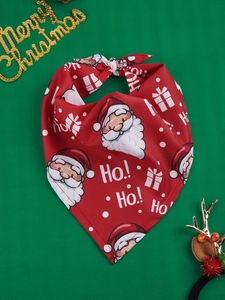 Detail of red Christmas pet bandana featuring Santa Claus and snowflake patterns