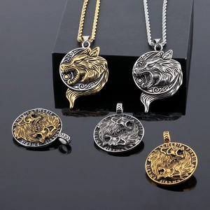 Macro detail of Nordic Viking wolf head pendant in gold and silver stainless steel