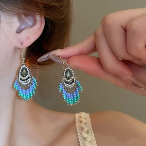 Close-up of bohemian beaded tassel earrings with vibrant multi-color ethnic fringe details