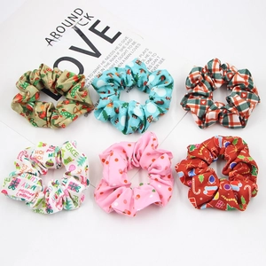 Detailed view of six Christmas themed fabric scrunchies with festive holiday patterns