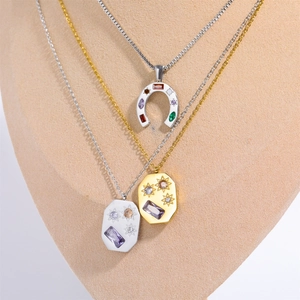 Close-up of three stacked stainless steel necklaces with zircon lucky charms on a mannequin