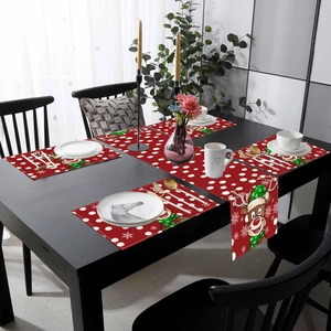 Christmas table runner and placemats set featuring reindeer and snowflake patterns on red