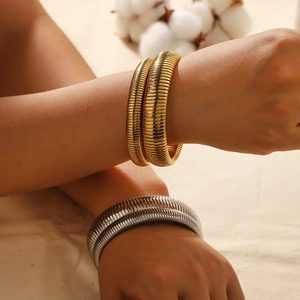 French vintage 18K gold and silver plated stretch tube bracelets worn by a model