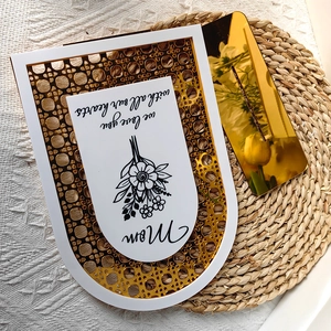 Macro shot of white and gold arch plaque with Mom quote on woven texture