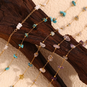 Detailed macro view of natural semi-precious stone chips on 18K gold plated anklet chain