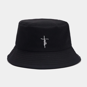 Close-up of white faith cross embroidery on black cotton twill bucket hat texture