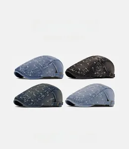 Detail view of denim flat caps featuring vintage distressed texture and adjustable metal buckle