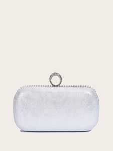 Detail of silver sequin evening bag featuring a crystal-embellished ring handle
