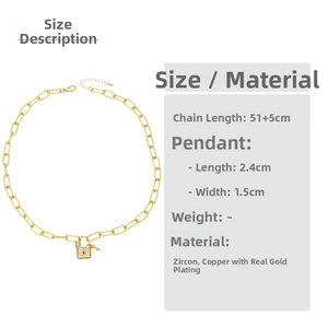 Detail view of gold-plated key and lock pendant necklace featuring micro-set zircon stones
