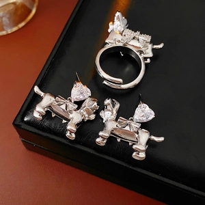 Detail of silver dachshund jewelry set with heart-shaped zircon and small pearls