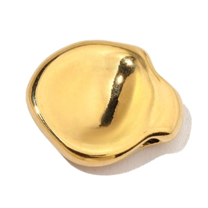 Macro detail of a minimalist polished gold-plated stainless steel bean pendant charm