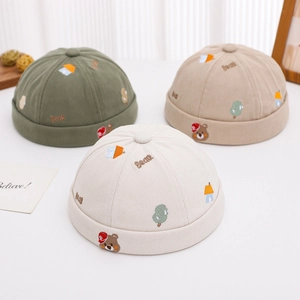 Three corduroy docker hats with cute bear embroidery in green, beige, and cream colors