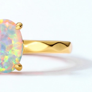 Macro view of oval opal ring with gold-plated 925 silver hammered texture band