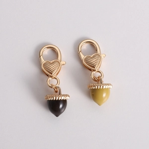 Detailed view of heart-shaped lobster clasps with creative cherry fruit pendants