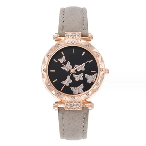 Detailed close-up of rose gold watch case with rhinestones and butterfly dial design