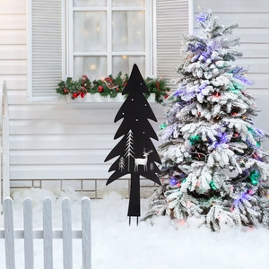 Christmas tree metal silhouette garden stake with reindeer pattern in snowy garden