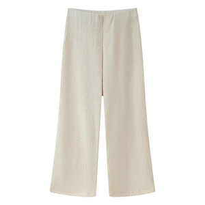 Detail of high waist wide-leg trousers with vertical pleats in oatmeal color