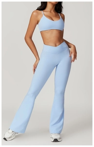 Detail of light blue flared yoga pants featuring a stylish V-cross high waistband design
