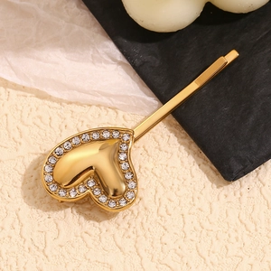 Close-up of 18K gold plated heart hair clip with sparkling rhinestones on the edge