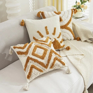 Detail of luxury bohemian pillow case with 3D tufting and yellow tassel fringe