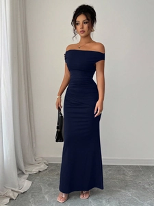Detail of elegant off-shoulder navy maxi dress featuring pleated texture and fishtail hem