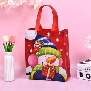 Red Christmas non-woven gift tote bag featuring a cute snowman and holiday snowflakes