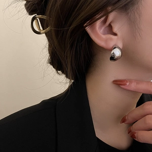 Minimalist silver geometric curved stud earrings with a polished mirror finish for women