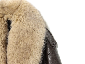 Detail of the detachable faux fur collar and textured leather shoulder on a brown jacket