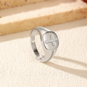 S925 silver signet ring with moissanite cross pattern on a beige textured background