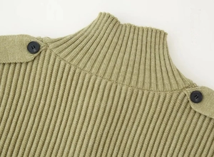 Detailed close-up of sage green ribbed knit sweater featuring decorative shoulder buttons