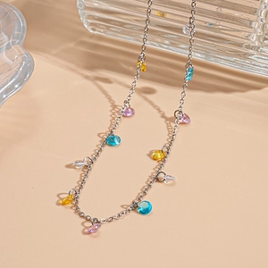 Detailed close-up of a silver chain necklace with multi-colored gemstone charms and rhinestones