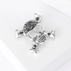 Punk silver skull and crossbones brooch with dark faceted gemstones for Halloween