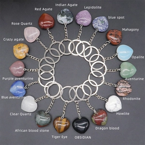 Flat lay of 18 varieties of 30mm heart-shaped natural crystal and agate stone keychains