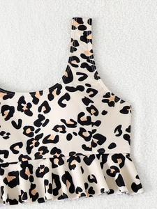 Close-up of leopard print bikini top featuring ruffled hem and wide straps