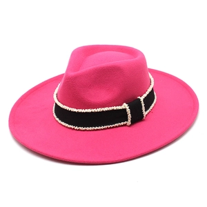 Detailed view of the fuchsia felt hat featuring a black ribbon with pearl-beaded edges