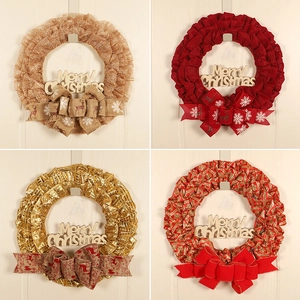 Detail view of four Christmas wreaths with Merry Christmas signs and decorative ribbons