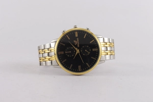 Macro detail of men's two-tone quartz watch with black dial and gold accents