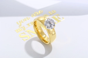 Close-up of a 6mm round zircon solitaire ring with golden finish and four-prong setting