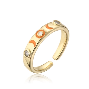 Detail of 18K gold plated copper ring with orange enamel moon and white zircon stones