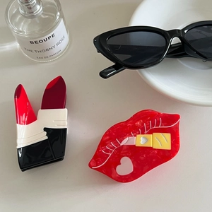 Lipstick and red lips acetate hair claw clips set on elegant cream background