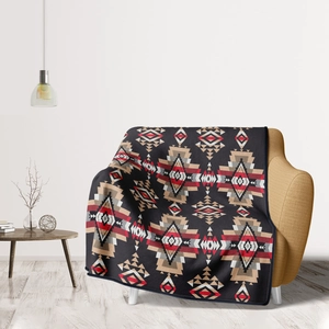 Detail view of Aztec geometric flannel blanket draped on a cozy yellow sofa in a living room