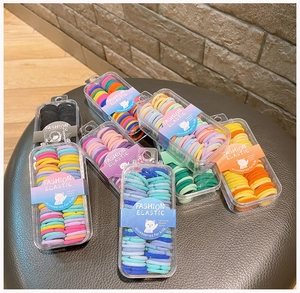 Close-up of colorful high-elastic children's hair ties in transparent storage boxes