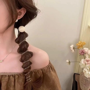 Spiral bubble hair tie with large white pearl bead for elegant wavy ponytail styling