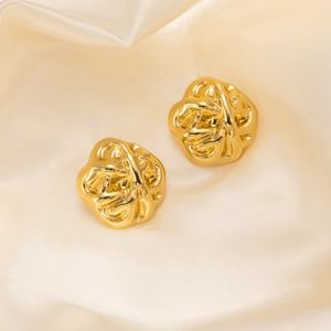 Vintage gold geometric irregular round earrings on a premium beige silk fabric background