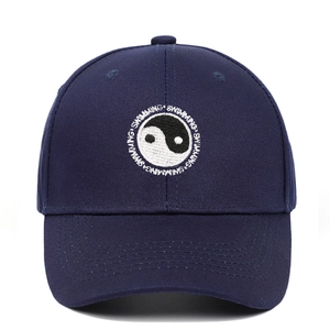 Close-up of Tai Chi Yin Yang embroidery and Swimming text on navy baseball cap