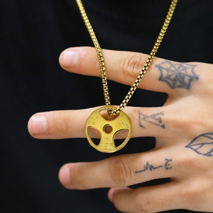 Detailed view of a gold dumbbell plate necklace featuring engraved Live Fit and Stay Toned text