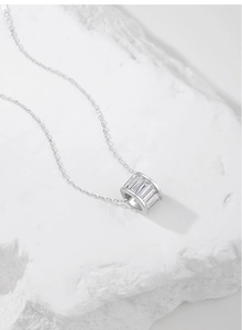 Macro shot of S925 sterling silver cylinder pendant with rectangular inlaid cubic zirconia