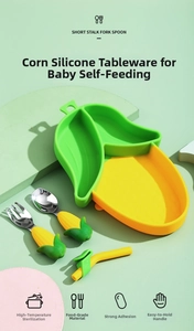 Detail view of corn-themed silicone suction plate with stainless steel fork and spoon set